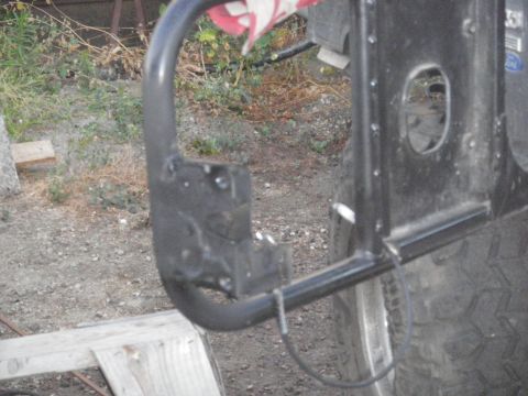 1991 Ford Bronco - Close-up of a vehicle's rear bumper and tire, with visible text from Supermotors.net.