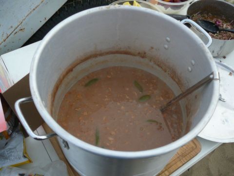 1988 Ford Bronco - A large pot of stew is shown, with other food containers nearby.