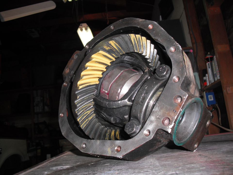 Close-up of a differential gear assembly with yellow and silver teeth