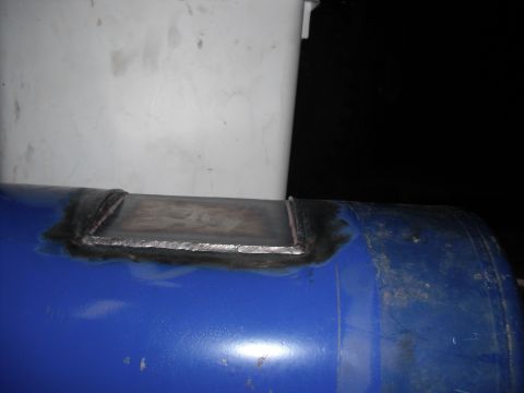 1991 Ford Bronco - A metal plate has been welded onto a blue cylindrical tank.