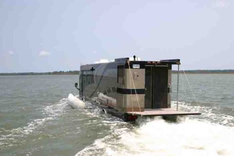 2001 Ford Crown Victoria - This custom houseboat RV navigates the waterways, leaving a wake behind it.