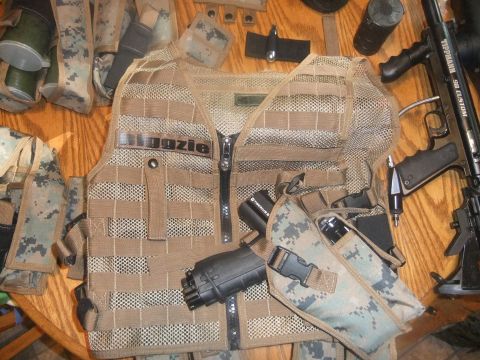 1978 Chevrolet C/K Pickup - Tactical vest and paintball gun laid out on a wooden table with various pouches and accessories.