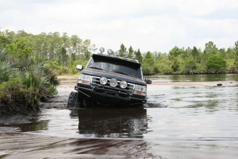 1993 Ford Bronco - This modified Ford Bronco is shown off-roading through a shallow body of water.