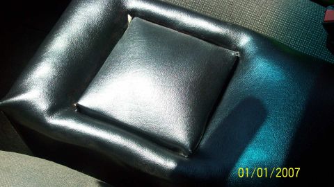 2004 Ford Crown Victoria - Interior view of a car's armrest, showing the padded center section and vinyl trim.