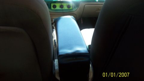 2004 Ford Crown Victoria - The interior of a 2004 Ford Crown Victoria is visible, focusing on the center console and dashboard.