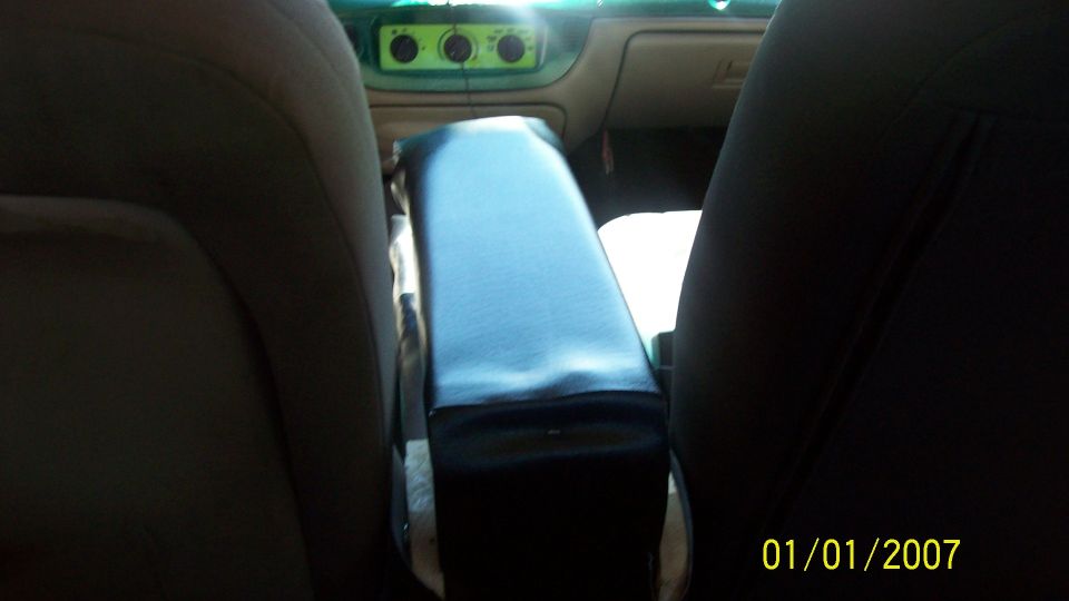 Interior of a 2004 Ford Crown Victoria showing the center console and dashboard with green climate controls
