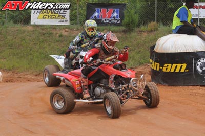 2004 Honda TRX 400 EX - ATV riders compete on a dusty track, with sponsors banners visible in the background.