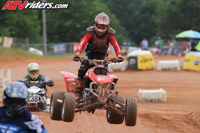 2004 Honda TRX 400 EX - Quad bikes compete on a dirt track during a race event.
