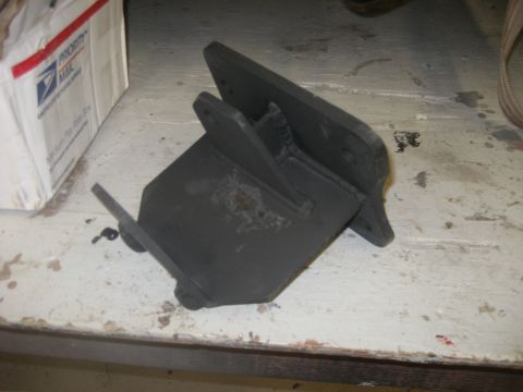 1978 Ford Bronco - A black metal bracket is shown on a workbench next to a shipping box.