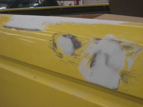 1978 Ford Bronco - This yellow truck bed is being prepped for paint, with visible body filler and sanding marks.