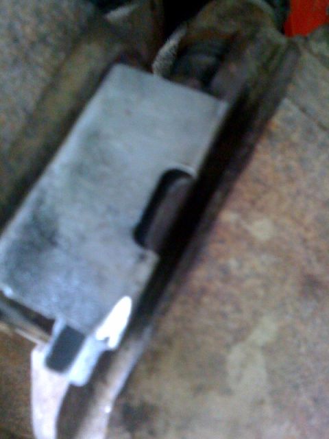 1995 Ford Bronco - A close-up view of a metal component, likely a vehicle part, with a distinct cutout.