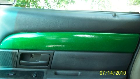 2004 Ford Crown Victoria - Interior view of a car's door panel, a custom metallic green accent strip.