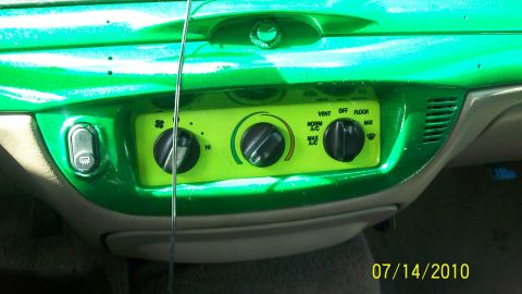 2004 Ford Crown Victoria - Interior view of a car's dashboard with custom green paint and climate controls.