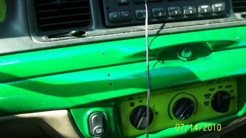 2004 Ford Crown Victoria - The interior dashboard features bright green paint and climate control knobs.