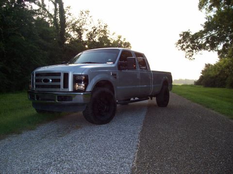 2008 Ford F-250 - 2008 Ford F-250 Super Duty pickup truck with black wheels on a gravel road.