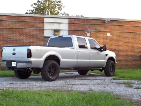2008 Ford F-250 - A silver 2008 Ford F-250 Super Duty pickup truck is viewed from the rear three-quarter angle.