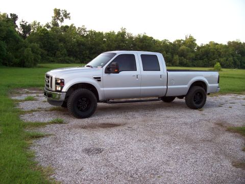 2008 Ford F-250 - This silver crew cab pickup truck is shown from a 3/4 front angle. The body style suggests it is a 2008 Ford F-250.