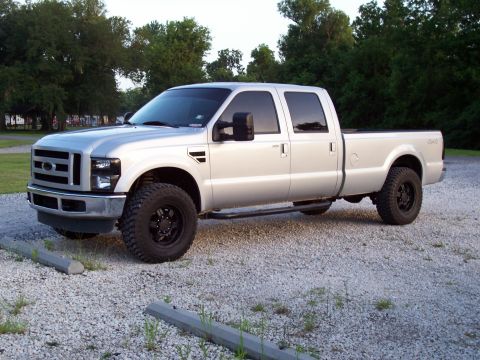 2008 Ford F-250 - Silver 2008 Ford F-250 Super Duty pickup truck with black wheels is parked on a gravel lot.