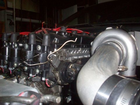 1992 Nissan 240SX - Close-up view of engine components, including a turbocharger and ignition system parts.