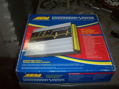 1992 Nissan 240SX - Box for an AEM Programmable Engine Management System, a silver ECU with yellow accents.