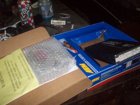 1992 Nissan 240SX - Contents of an AEM Programmable Engine Management System box, including the unit and other items.