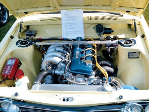 1992 Nissan 240SX - The engine bay of a classic car, a Nissan Twin Cam engine and various aftermarket parts.