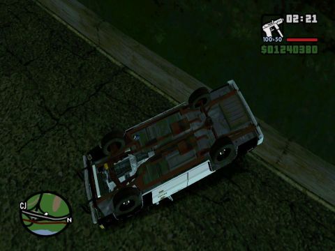 2000 Mercury Grand Marquis - A car lies overturned on a rural road, its undercarriage exposed to the elements.