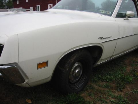 1971 Ford Ranchero - Close-up of the front quarter panel and wheel of a white 1971 Ford Ranchero.