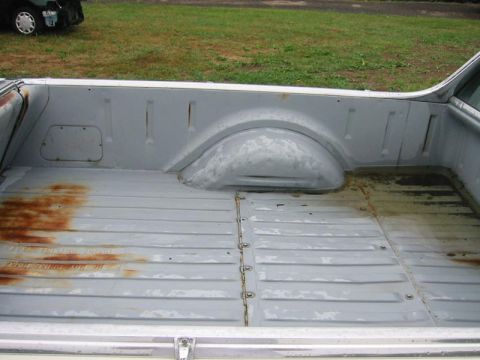 1971 Ford Ranchero - The bed of a pickup truck shows signs of wear and rust.