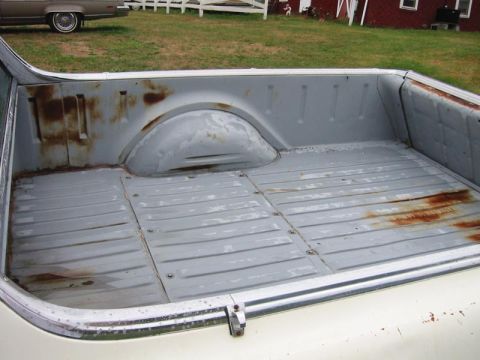 1971 Ford Ranchero - The bed of a pickup truck shows signs of wear and rust, with another vehicle visible in the background.