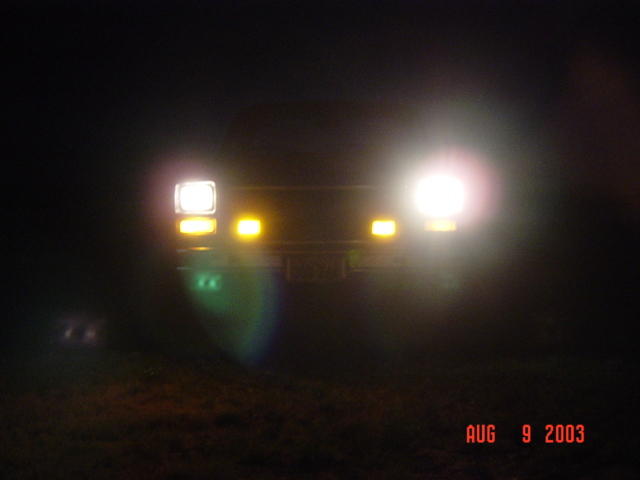 Truck at night with headlights and amber clearance lights glowing, dated Aug 9 2003