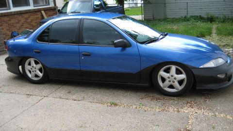 1996 Chevrolet Cavalier - This blue 1996 Chevrolet Cavalier sedan features a two-tone paint scheme with black trim and aftermarket wheels, sitting low on its suspens…