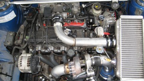 1996 Chevrolet Cavalier - Custom turbocharged engine bay with aftermarket parts installed.