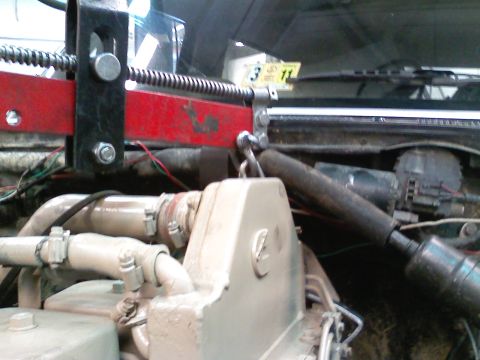 1990 Ford Bronco - A hoist is positioned over the engine in this vehicle's engine bay.