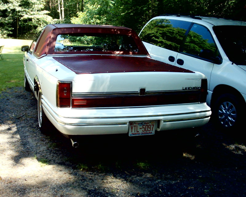 White Lincoln Ranchero with maroon vinyl top and tonneau cover, rear view