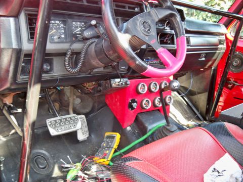1985 Ford Bronco - Customized 1985 Ford Bronco interior features a roll cage, racing seats, and additional gauges.