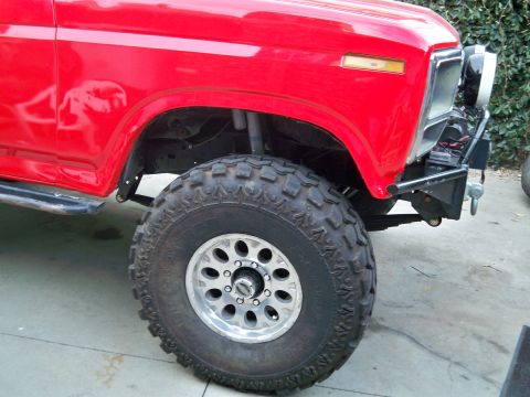 1985 Ford Bronco - Front view of a red 1978 Ford Bronco with off-road modifications.
