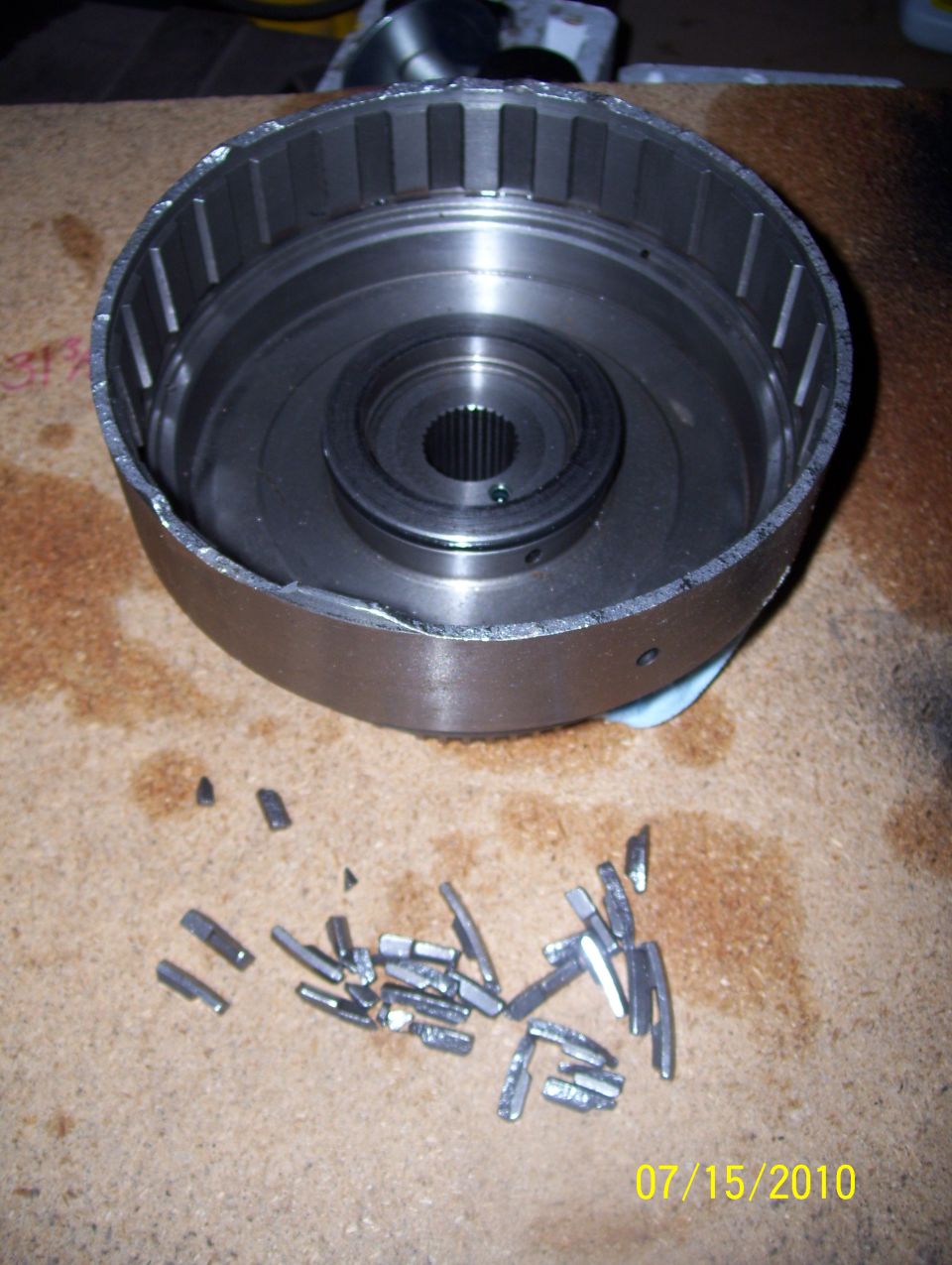 Transmission drum and broken pieces on a workbench