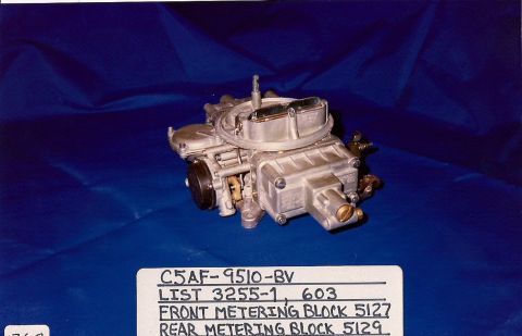 1973 Ford Mustang - A close-up view of a carburetor, identified by part numbers and descriptions on a label below it.