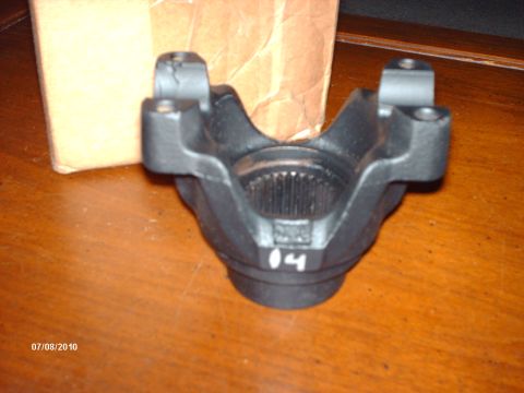 1982 Ford F-100 - Close-up of a driveshaft U-joint yoke, marked with '04' in white paint.