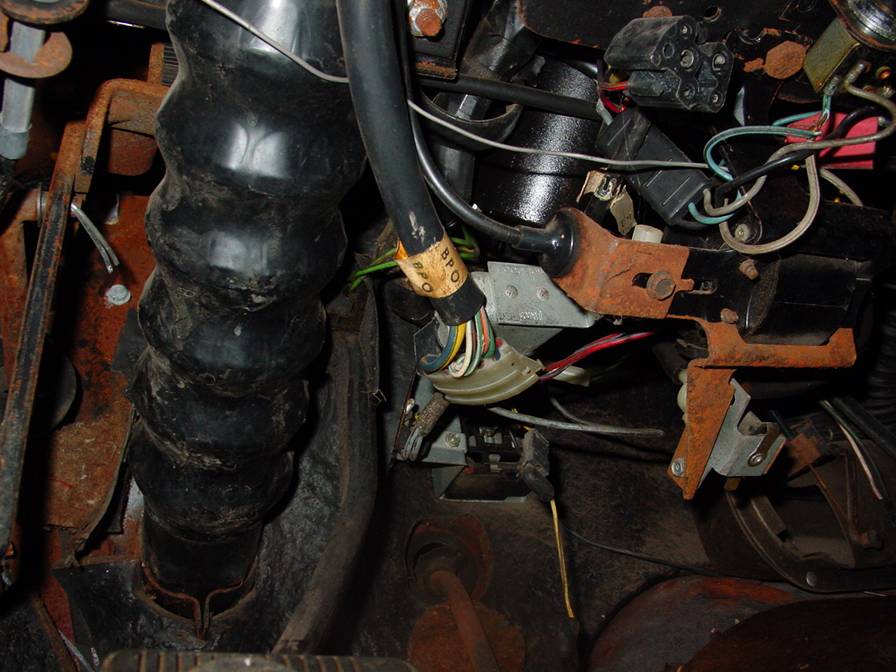 Close-up of car's steering column wiring harness and rubber boot