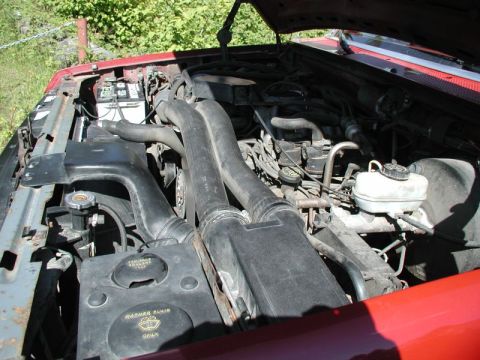 1990 Ford F-250 - Engine bay of a 1990 Ford F-250, showing the large air intake system and engine components.