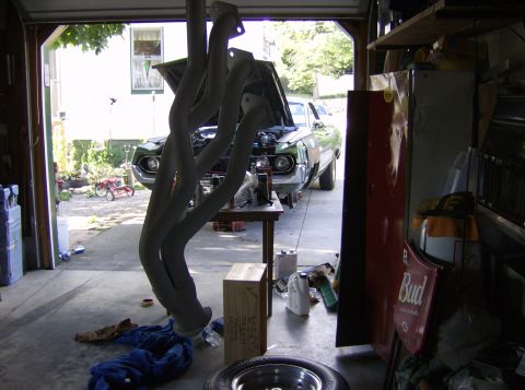 1970 Ford Ranchero - A 1970 Ford Ranchero is in a garage with exhaust headers in the foreground.