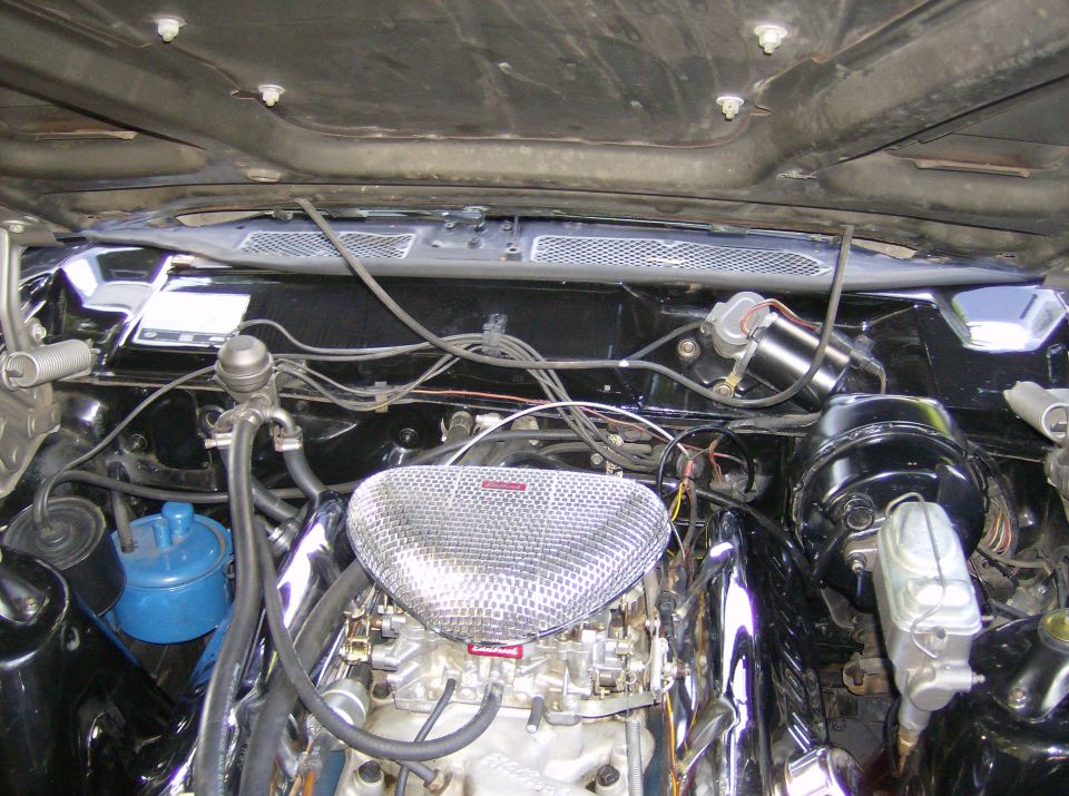 Black engine bay with V8, Edelbrock carb and chrome triangular mesh air cleaner