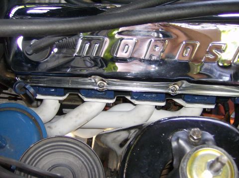 1970 Ford Ranchero - Close-up of a chrome Moroso valve cover with white exhaust headers visible below.