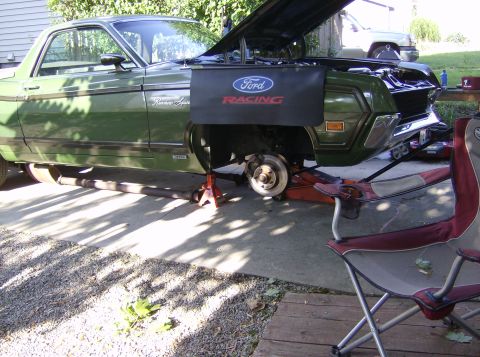 1970 Ford Ranchero - 1970 Ford Ranchero undergoing maintenance with the hood up and front wheel removed.