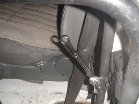 1991 Ford Bronco - A wrench is positioned on the interior trim of a vehicle, obscuring most of the view.