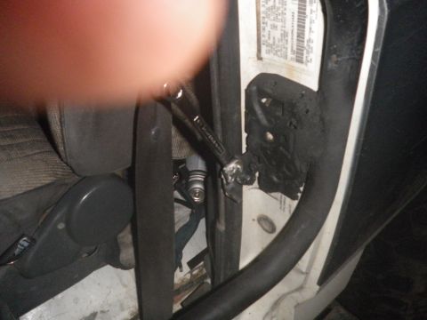 1991 Ford Bronco - A wrench is used to adjust the door latch mechanism on the interior of a vehicle.