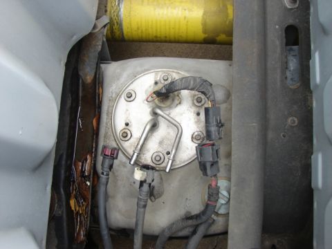 2007 Ford Mustang - Close-up view of a vehicle's fuel pump assembly, showing its various components and connections.