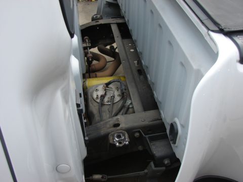 2007 Ford Mustang - Pickup truck underbody with fuel tank and exhaust pipes visible.